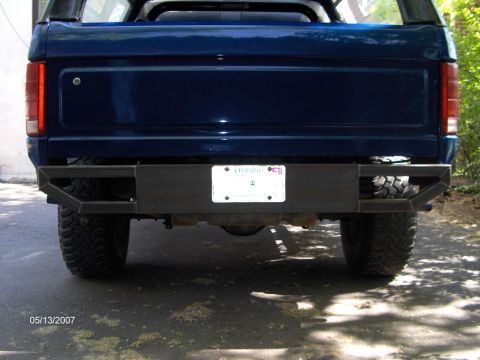 1986 Ford Bronco - The rear of a blue SUV is shown with a custom metal bumper and an Ontario license plate attached.