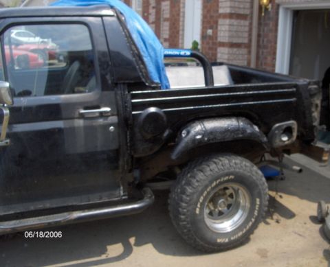 1986 Ford Bronco - This black Ford Bronco appears to be undergoing some work, with the rear quarter panel removed.