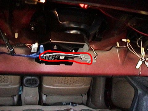 1996 Ford Taurus - Wiring harness connector block circled in red, viewed from inside a vehicle.