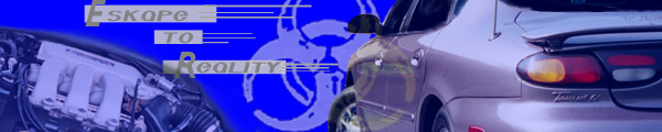 Rear quarter panel of a 1996 Ford Taurus with a spoiler and a badge