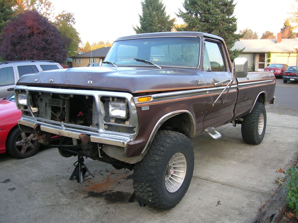 1978 Ford F-250 pickup truck, front end removed, on jack stands. Brown paint with chrome trim