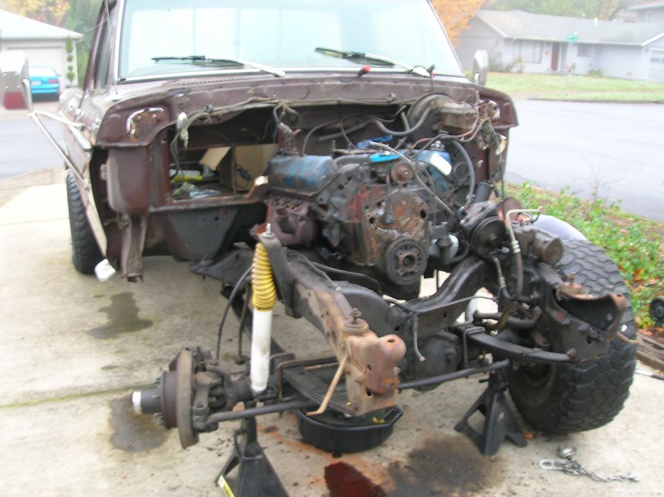 Front end of a disassembled 1978 Ford F-250 truck, engine out, sitting on jack stands