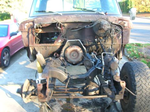 1978 Ford F-250 - The front end of a truck is disassembled, showing the chassis and suspension components.