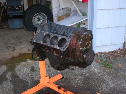 1978 Ford F-250 - A V8 engine block, likely removed from a vehicle, sits on an orange engine stand.