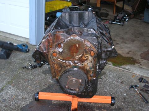 1978 Ford F-250 - Engine block on a stand, showing signs of rust and wear. Tools are scattered around the area.