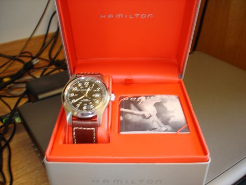 1994 Ford Bronco - A Hamilton watch with a brown leather strap is displayed in its orange presentation box next to product literature.