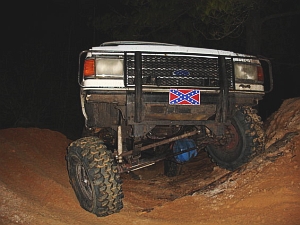 1986 Ford Bronco - This SUV is equipped for off-road use and features a prominent Confederate flag emblem on its front grille.
