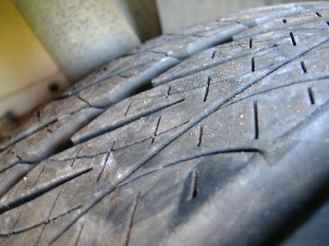 1999 Ford Mustang - A close-up view of a vehicle's tire tread, showing wear and tear.