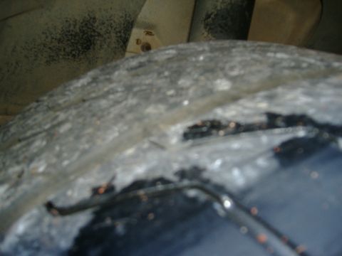 1999 Ford Mustang - A close-up view of a tire and fender liner shows wear and tear.