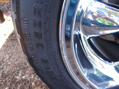 1999 Ford Mustang - Tire and chrome wheel detail, showing tire size P215/35ZR17.