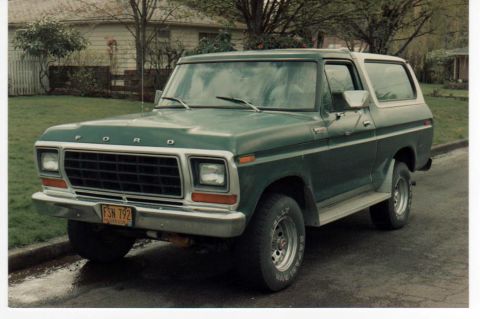 1979 Ford Bronco - This 1979 Ford Bronco, seen from a three-quarter front view, is a classic SUV with a distinctive green body and white roof.
