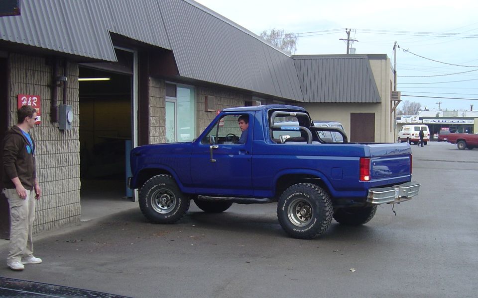 Blue 1986 Ford Bronco 3/4 front view with roll bar