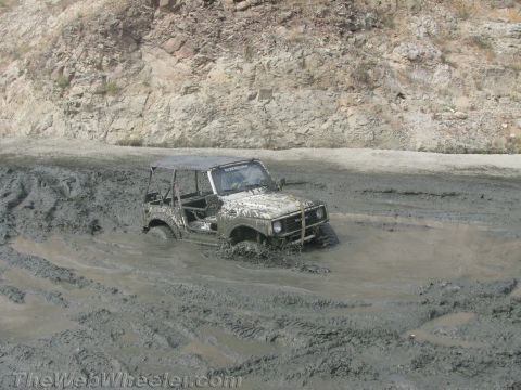1987 Suzuki Samurai - Suzuki Samurai deep in mud during off-road adventure.