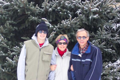 1996 Ford Taurus - Family poses for a photo in front of snow-covered pine trees during winter.