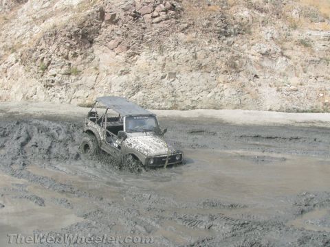 1987 Suzuki Samurai - This 1987 Suzuki Samurai navigates a challenging muddy terrain.