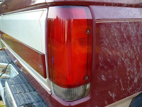 1988 Ford Bronco - Close-up of a 1988 Ford Bronco's rear tail light assembly and body panel.