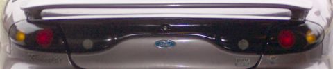 1996 Ford Taurus - The rear of a 1996 Ford Taurus features a spoiler and distinctive dark-tinted taillights.