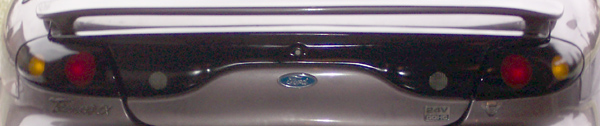 Rear view of a 1996 Ford Taurus with a spoiler and red taillights