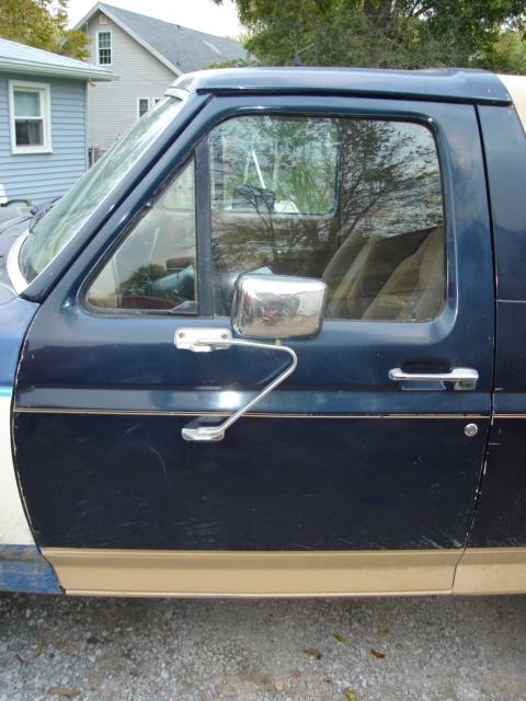 1990 Ford Bronco - Drivers door, needs dent popped out.