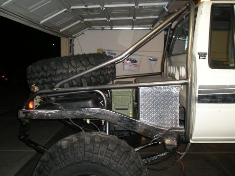 1986 Toyota Hilux - Custom rear storage and spare tire mount on a modified truck.
