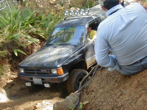 1994 Ford Explorer - Toyota 4Runner navigating a challenging off-road obstacle.