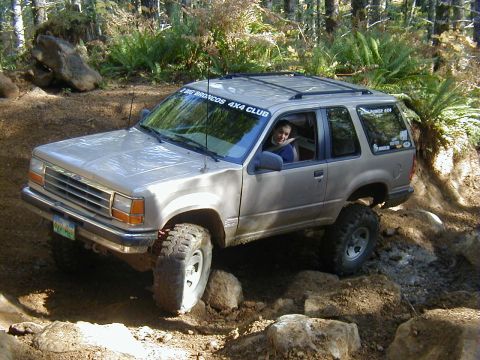 1994 Ford Explorer - Ford Explorer tackling a challenging off-road course in a wooded area.
