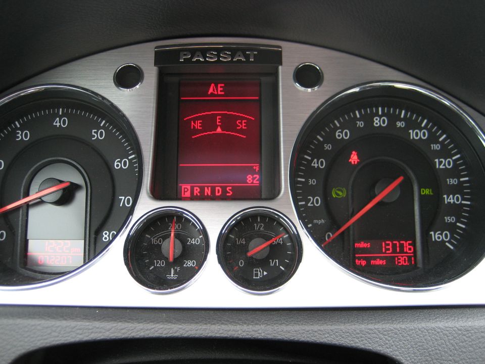 Volkswagen Passat gauge cluster with red digital display, 13776 miles, compass and 82°F readout