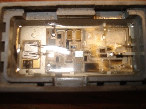 1986 Ford Bronco - This image shows a detailed view of an electronic circuit board with multiple components and visible wear.