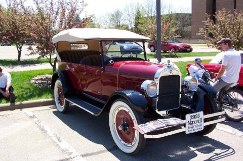 1996 Ford Taurus - A vintage 1923 Maxwell touring car is displayed outdoors, with a sign identifying it.