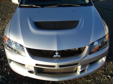1995 Ford Probe - Front view of a silver Mitsubishi Lancer Evolution, likely from the 2005-2007 model range.