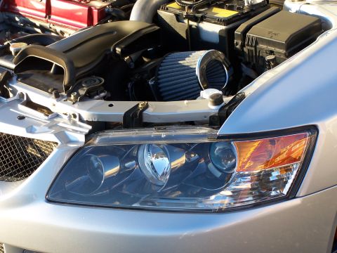 1995 Ford Probe - Close-up of a car's engine bay with an aftermarket air intake system visible.