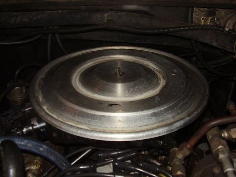 1986 Ford Bronco - Close-up of the engine's air cleaner assembly, showing hoses and wiring.