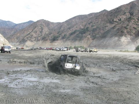1987 Suzuki Samurai - A 1987 Suzuki Samurai navigates a challenging mud pit during an off-road event.