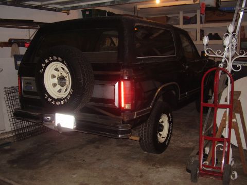1986 Ford Bronco - This SUV, likely from the 1980s, is parked indoors with its rear facing the camera.