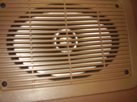 1986 Ford Bronco - Close-up of a vehicle's interior speaker grille, showing the speaker behind the protective slats.