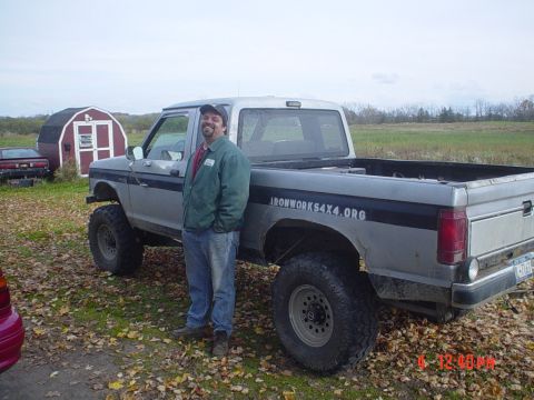 1990 Ford Ranger - A 1990 Ford Ranger pickup truck is shown with a man standing beside it. The truck has "IRONWORKS4X4.ORG" written on the side of the bed.