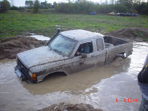 1990 Ford Ranger - A 1990 Ford Ranger is stuck in a muddy puddle, with a snorkel attached to the A-pillar.