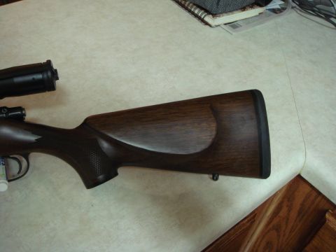 1992 Ford Bronco - A close-up view of a rifle's wooden stock and scope.