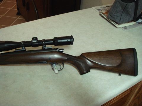 1992 Ford Bronco - A hunting rifle with a scope is shown on a table.