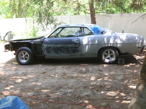 1969 Ford Torino - This 1969 Ford Torino coupe is in a state of disrepair, with its front end disassembled and primer gray paint.