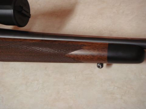 1992 Ford Bronco - Close-up view of a rifle scope and its wooden stock, detailed checkering.