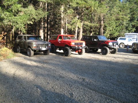 1989 Ford Bronco - Three lifted Ford Broncos parked in a forest during Winterfest 2007.
