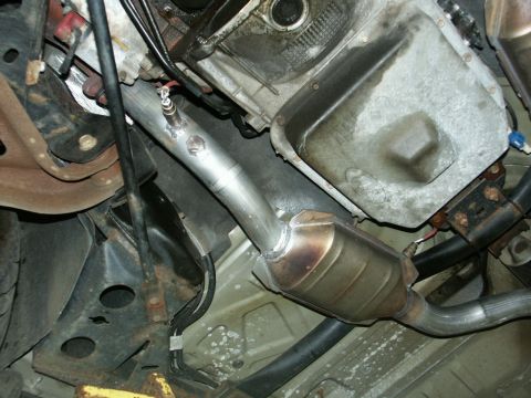 2001 Mercury Grand Marquis - Close-up view of the exhaust system components, including the catalytic converter and piping.