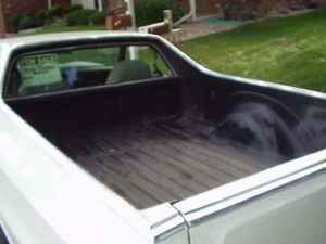 1973 Ford Ranchero - The bed of a white 1973 Ford Ranchero pickup truck is shown from a rear-facing perspective.
