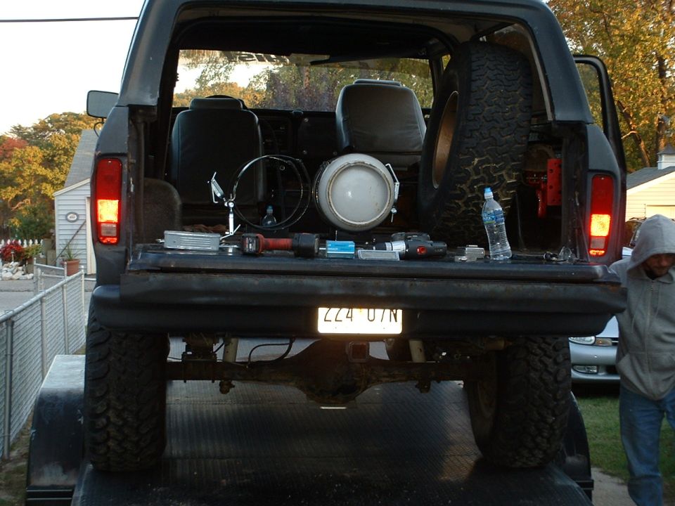 1978 Ford Bronco tailgate open, showing spare tire, seats, and tools