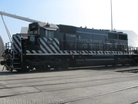 1990 Ford Bronco - Side view of a black Pacific Harbor Line diesel locomotive numbered 60, with white safety striping along its frame.