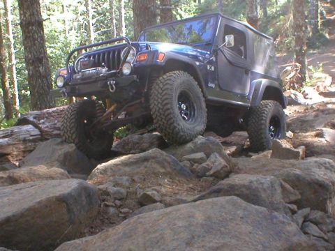2005 Jeep Wrangler - This Jeep Wrangler is navigating a rocky trail with its front tire elevated.