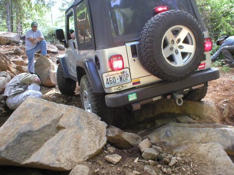 2005 Jeep Wrangler - A Jeep Wrangler tackles a challenging rocky terrain, demonstrating its off-road capabilities.