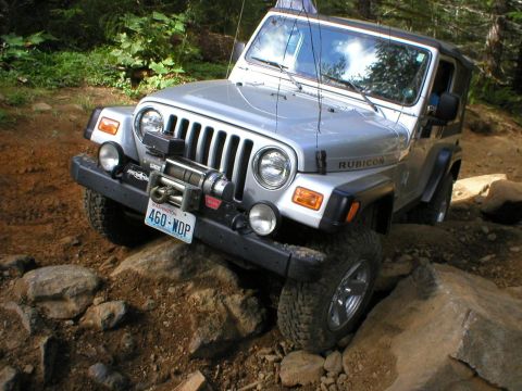 2005 Jeep Wrangler - A silver 2005 Jeep Wrangler Rubicon navigates a rocky off-road path.