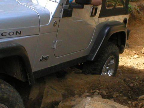 2005 Jeep Wrangler - This Jeep Wrangler is navigating a rocky trail, demonstrating its off-road capabilities.